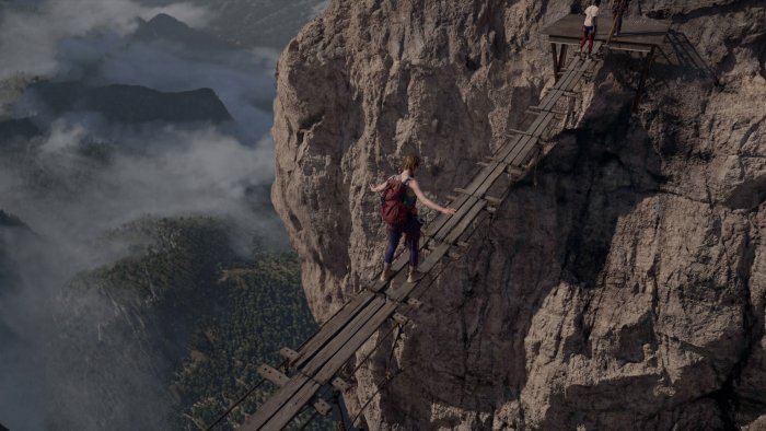 Woman crossing a precarious suspension bridge in Fall 2: Deadpoint