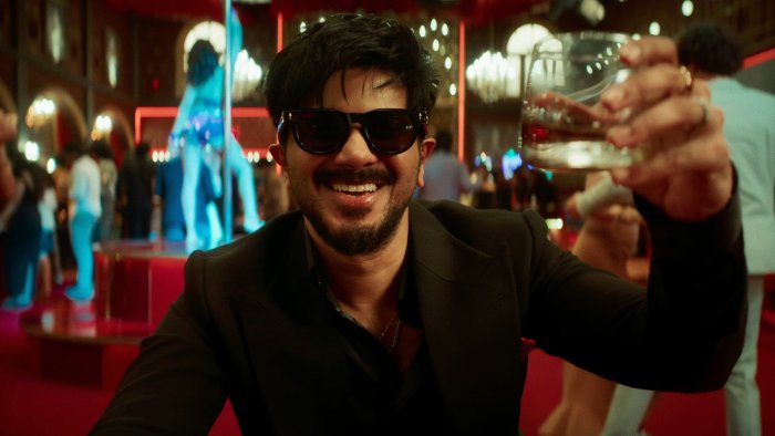 Dulquer Salmaan raising a glass in I'm Game