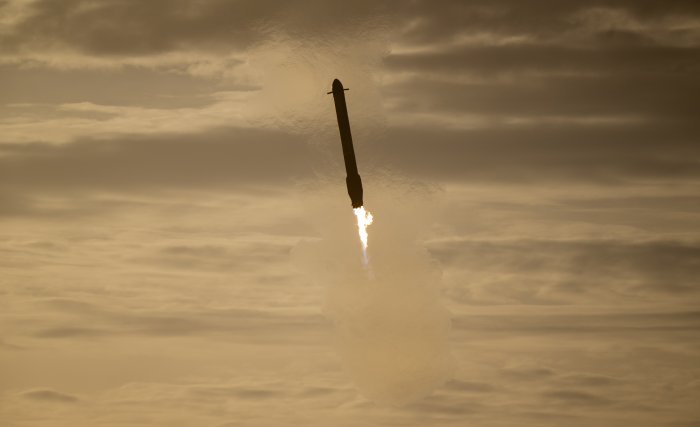 SpaceX Falcon Rocket Booster Descending Through Clouds