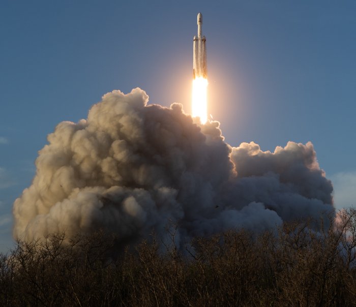 SpaceX Falcon Heavy Rocket Launching into Blue Sky