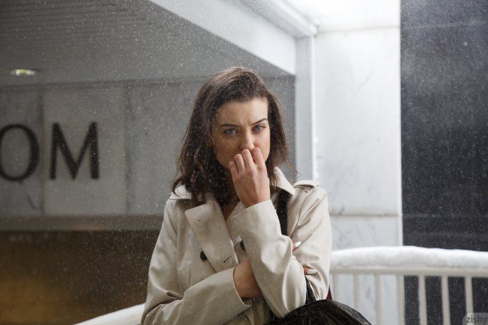 Woman in Trench Coat Standing in the Snow