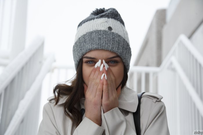 Woman in Winter Beanie Covering Her Face