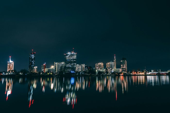 Vienna Donau City skyline reflected in water at night