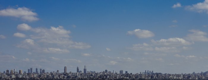 Panoramic view of a city skyline under blue sky