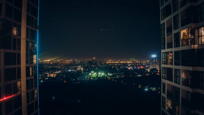 Night view of a city between two tall buildings