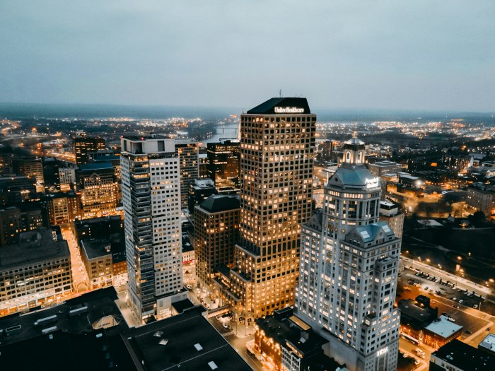 Aerial view of illuminated city skyscrapers at dusk