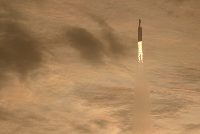 SpaceX Falcon Heavy Rocket Launching into Golden Clouds