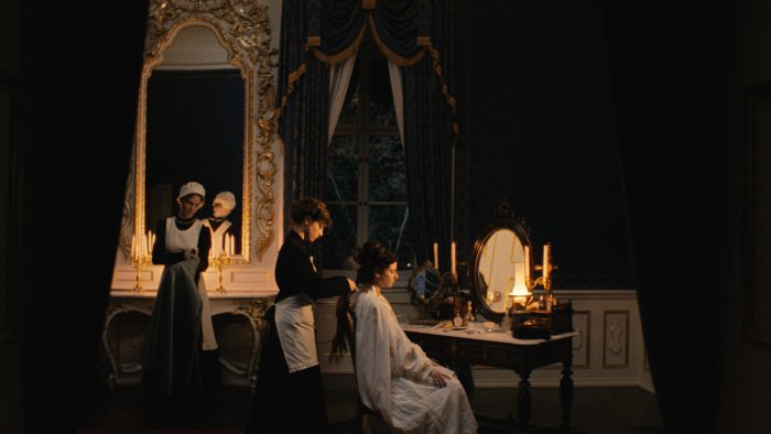 Maids styling a woman's hair in Fanny
