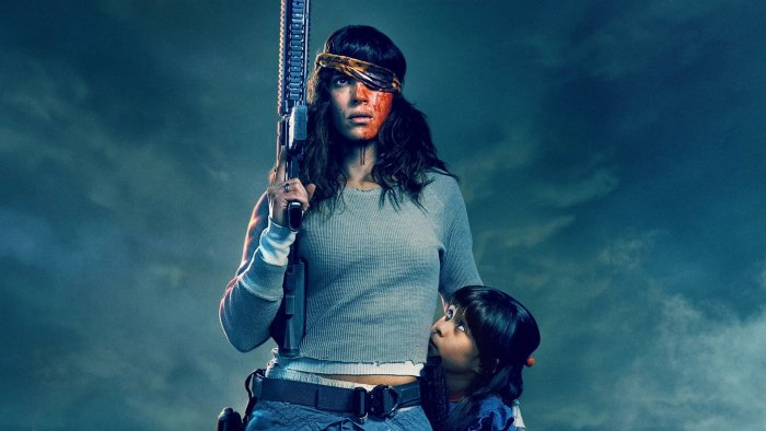 Adria Arjona holding a rifle in Onslaught