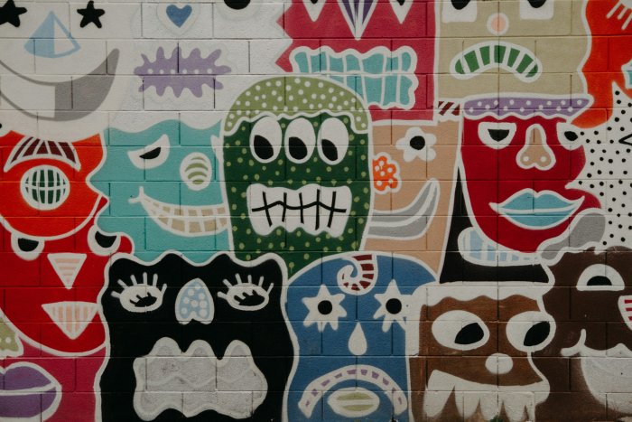 Colorful graffiti mural of cartoon monster faces