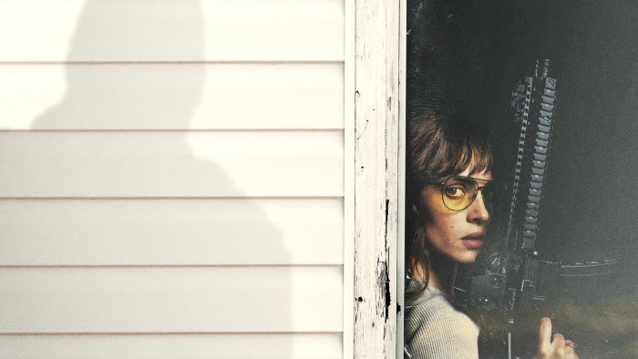 Adria Arjona holding a rifle in Onslaught