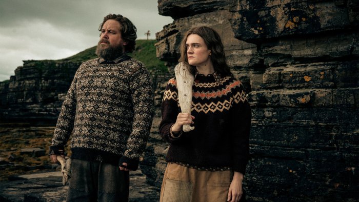 Man and woman in patterned sweaters in The Incomer