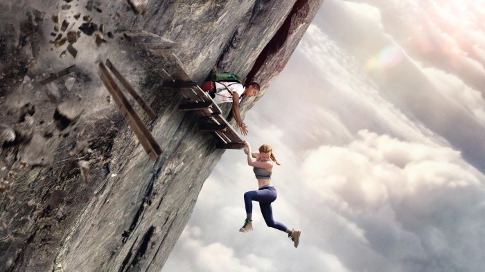 Two women climbing a collapsing cliff face