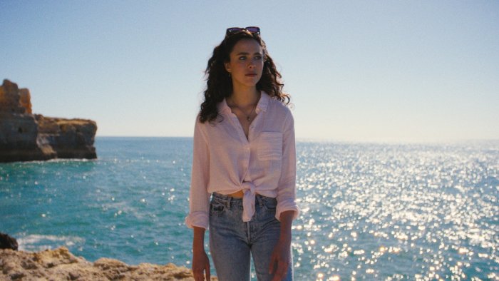 Woman on a cliff overlooking the ocean