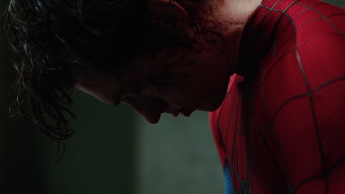 Spider-Man with bloody face looking down