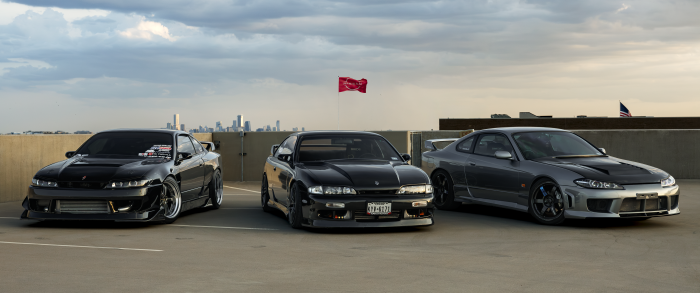 Three modified Nissan Silvia cars parked on a rooftop