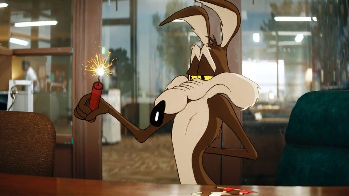Wile E. Coyote holding a lit dynamite stick