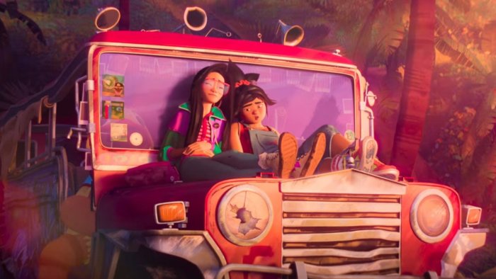 Two girls in a red jeep in a jungle