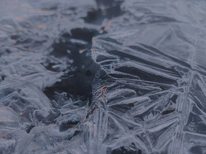 Close-up of jagged ice formations on a dark surface