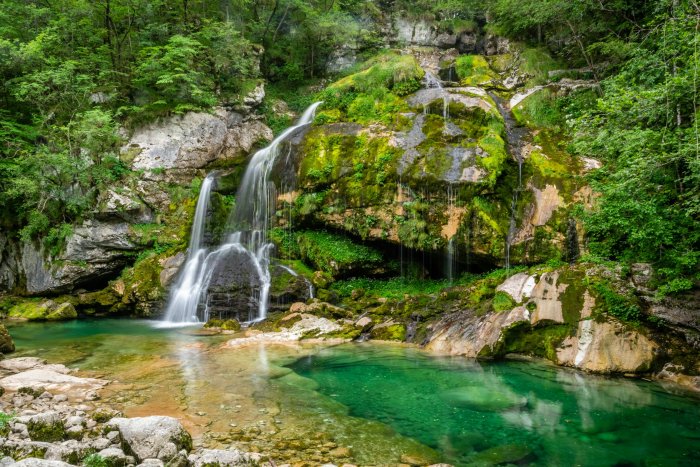 Waterfall cascading into a clear turquoise pool