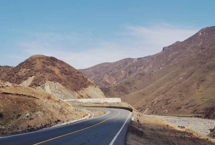 Winding mountain road under a clear blue sky