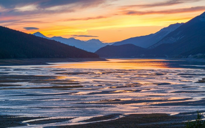 Sunset over a mountain lake with exposed sandbars