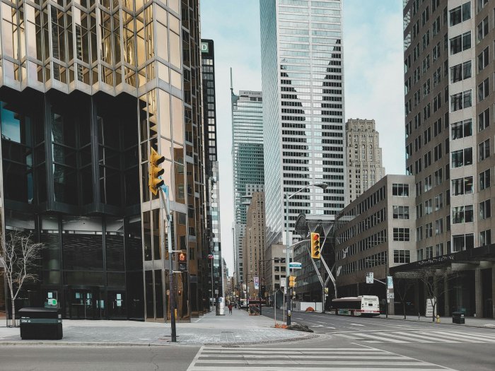 City street with modern skyscrapers and a bus
