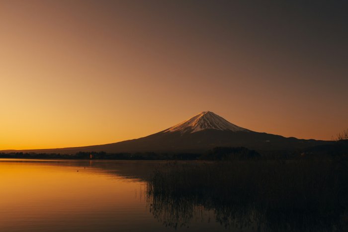 Mount Fuji reflected in a lake at sunset