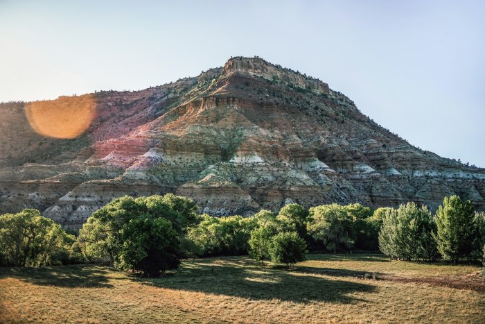 Layered mountain with trees at sunset