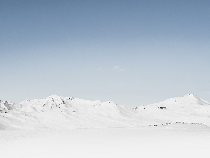 Snow-covered mountains under a clear blue sky