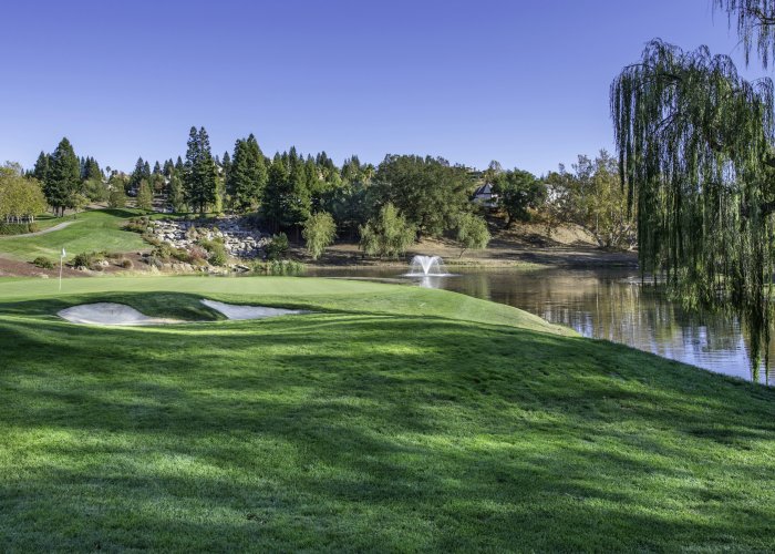 Golf course with a lake and fountain