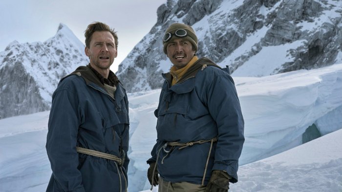 Two men in winter jackets on a snowy mountain