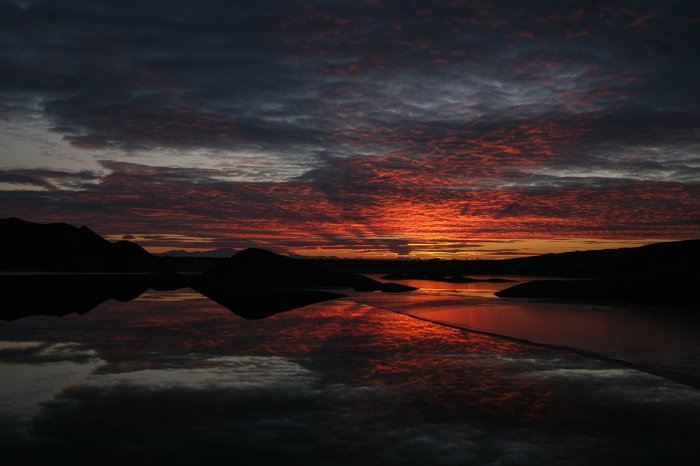 Sunset over a lake with mountains