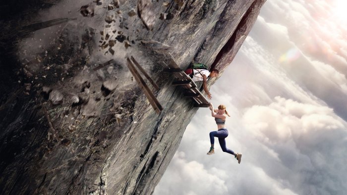 Two women clinging to a collapsing cliffside structure