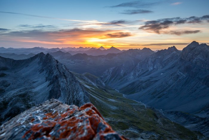 Mountain valley at sunset with colorful sky