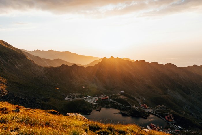 Mountain valley with lake at sunset