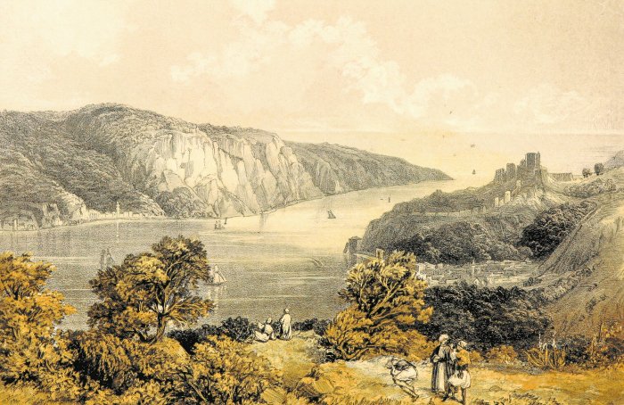 Scenic view of a river valley with a castle and people