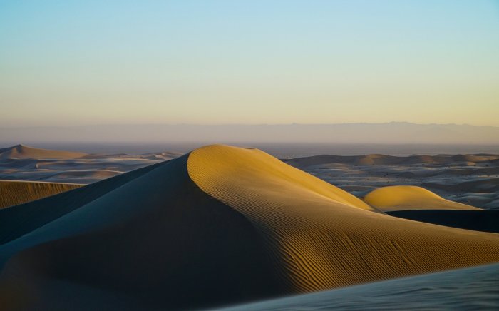 Desert sand dunes at sunset