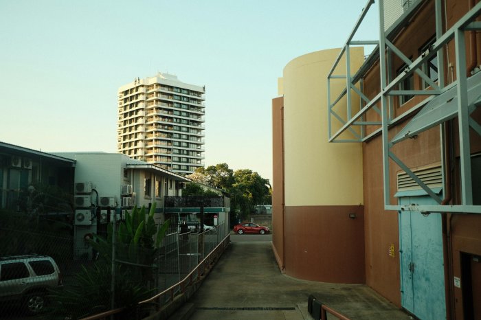 Modern buildings and a red car on a street