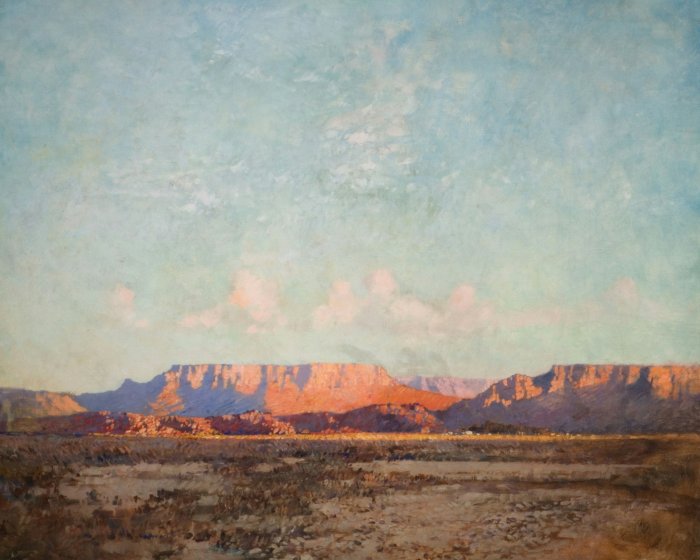 Desert landscape with mesas at sunset