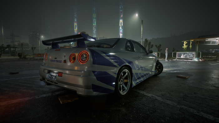 Nissan Skyline GT-R R34 with blue decals at night