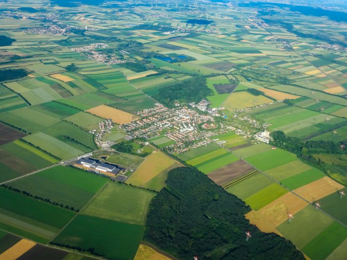 Aerial view of agricultural fields and a town