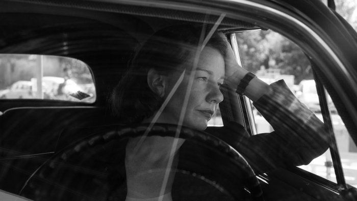 Woman in vintage car looking out window