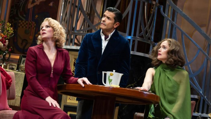 Three people on a stage with a table