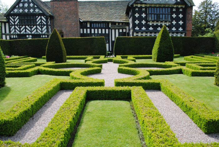 Formal garden with Tudor-style house