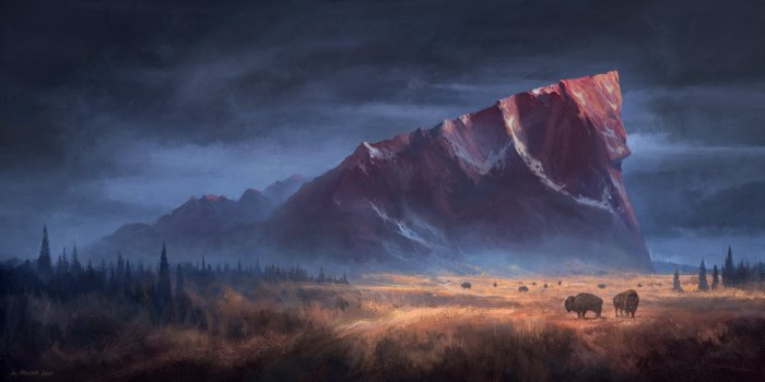 Bison herd in front of a large red mountain