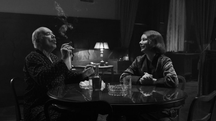 Man smoking cigar and woman talking at table