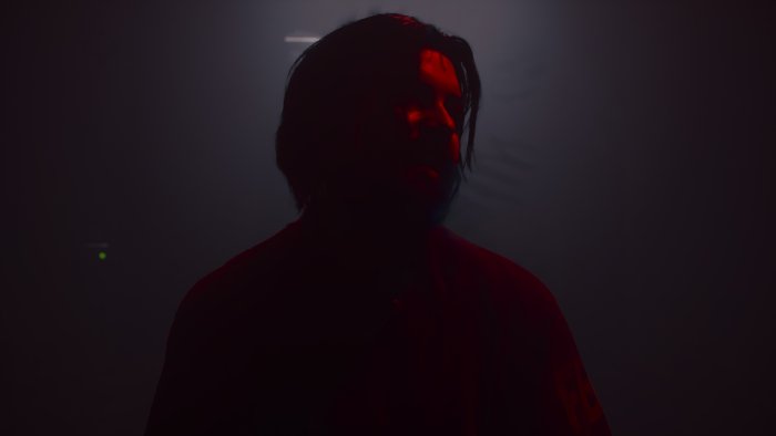 Man in red light, dark background