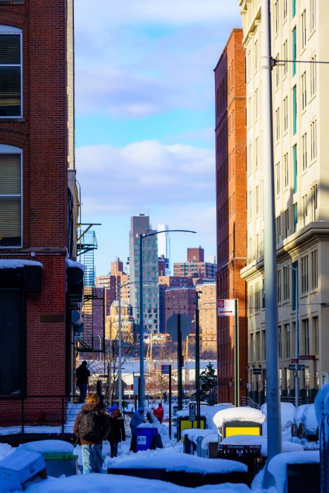 Snowy street with people and city skyline