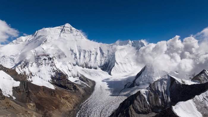 Snow-covered mountains under a blue sky